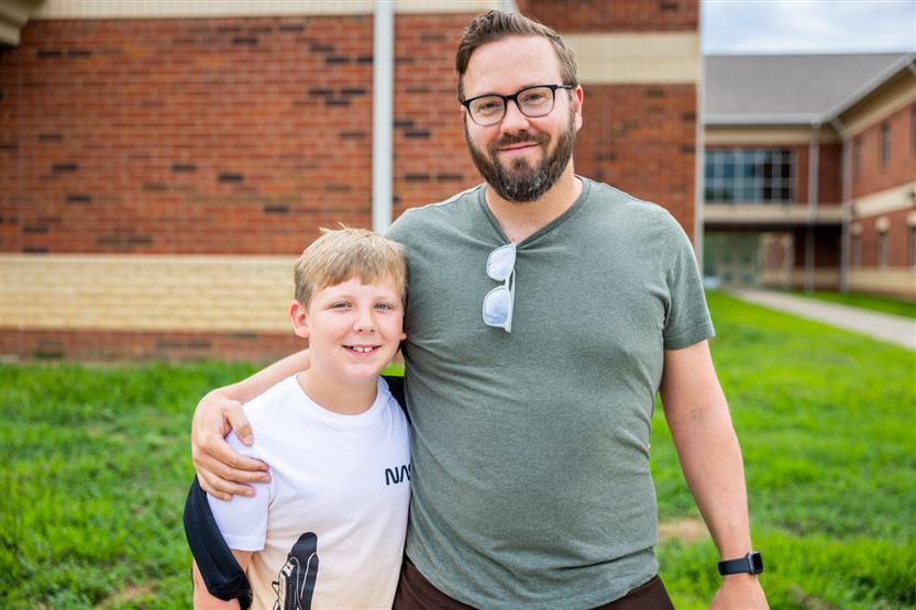 A father and student smile